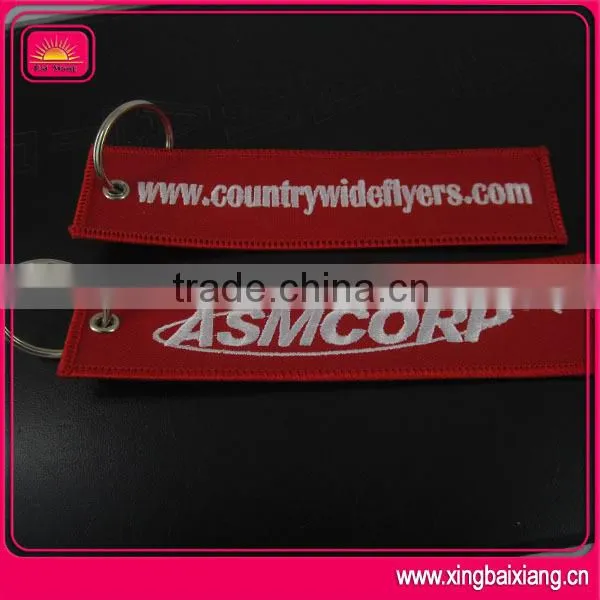 customized remove before flight spinning keychain