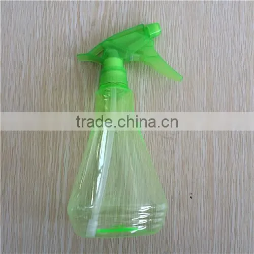 green transparent plastic garden spray bottle with trigger