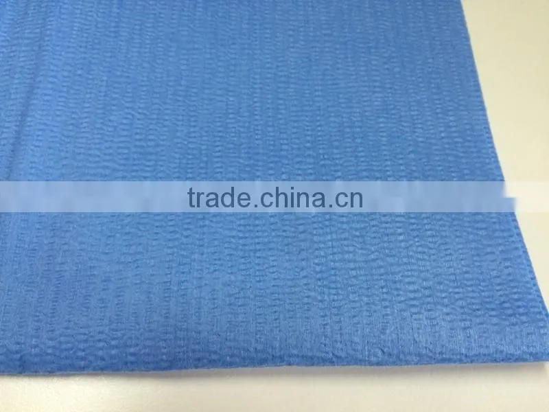Creped nonwoven spunlace woodpulp polyester