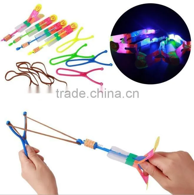Hot sellingElastic Toy Gift Flash Rotating Flying Arrow Rocket Helicopter/kids light up led rubbe band flashing led flying arrow