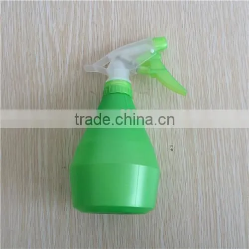 green plastic garden spray bottle with trigger