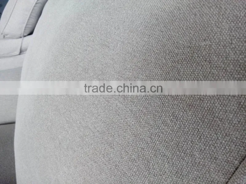 beige linen sofa with metal rolling castor
