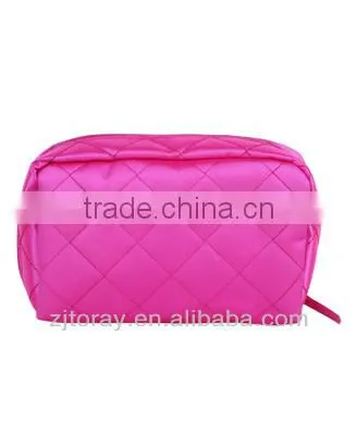 Lightweight quilted cosmetic bag featuring a zippered placket along the top and sides