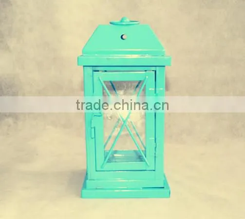 green metal lantern with clear glass wall