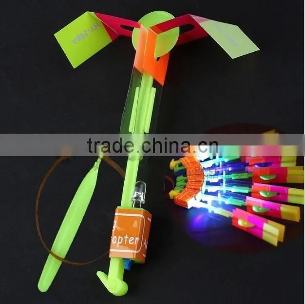 Hot sellingElastic Toy Gift Flash Rotating Flying Arrow Rocket Helicopter/kids light up led rubbe band flashing led flying arrow
