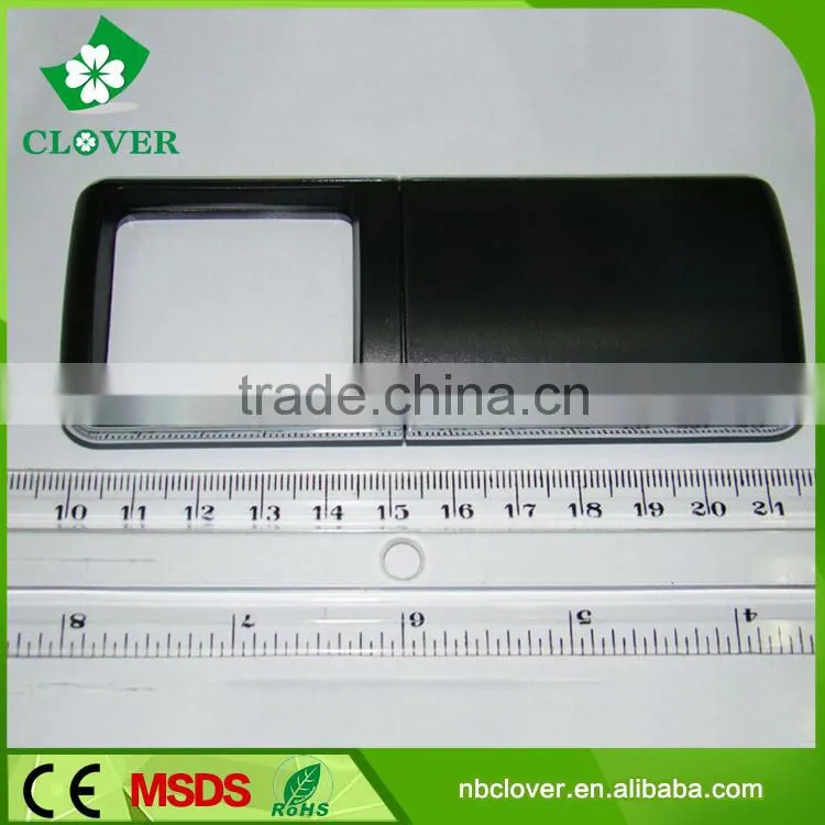 Reading using plastic portable magnifying glass with light