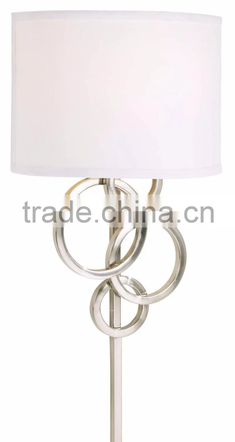 1017-1 sleek brushed steel finish raindrops falling on a calm body of water intertwining Circles Plug-In Wall Sconce