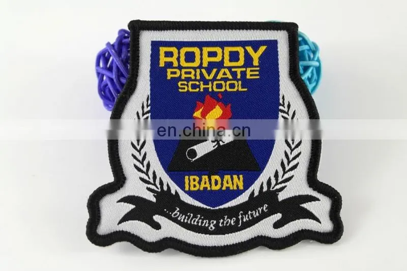 die cut shape with logo book and bird woven military emblems