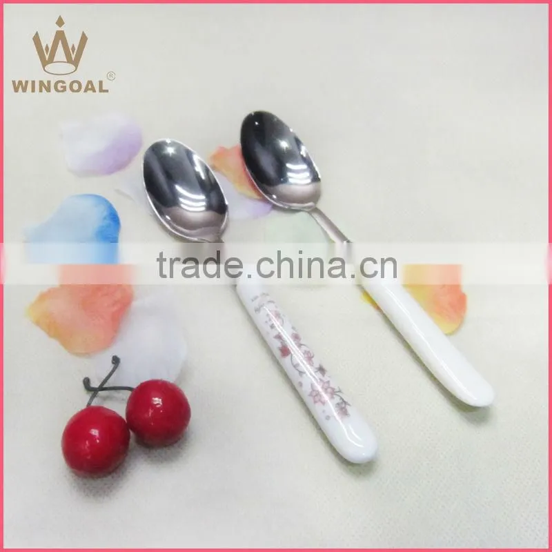 Stainless spoon with porcelain handle