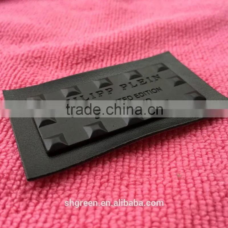 Shiny golden color metal badge on black leather
