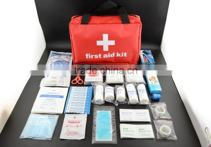 Emergency first aid travel kit in red cross bag for outdoor treatment