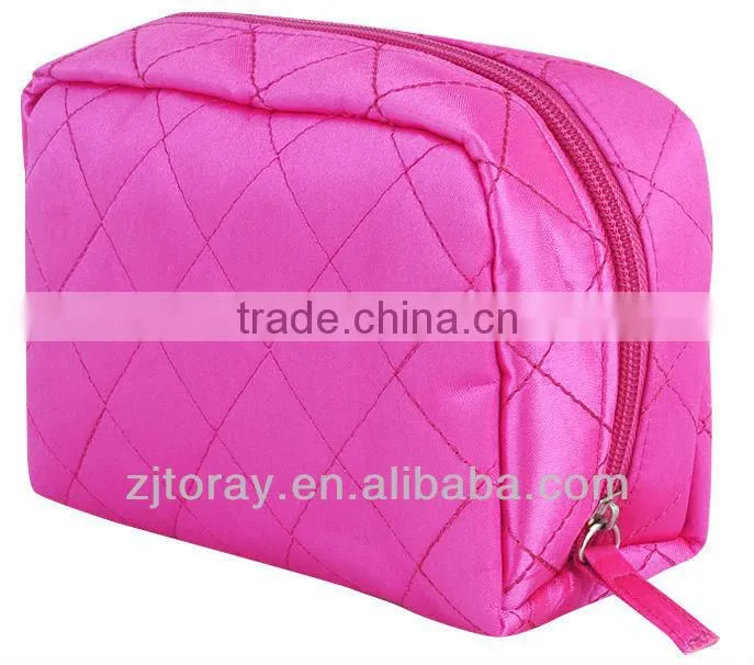 Lightweight quilted cosmetic bag featuring a zippered placket along the top and sides