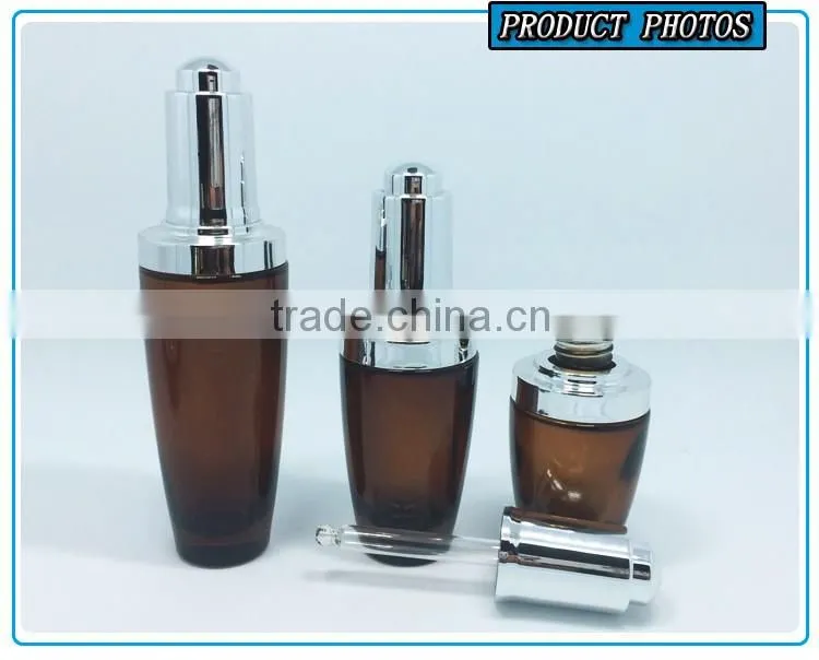Amber coloured cosmetic glass lotion bottles with silver pump cap