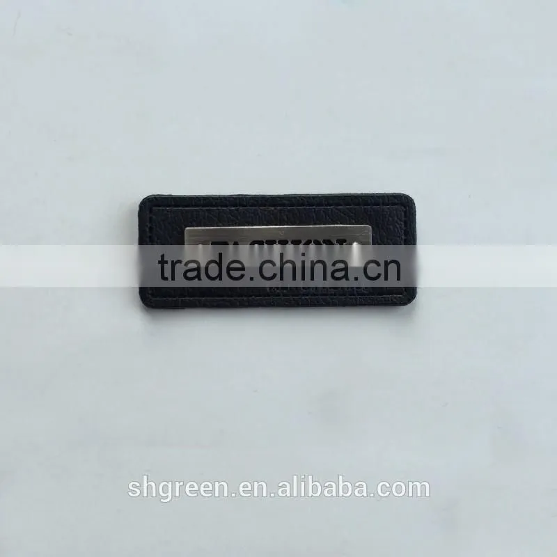 Embossed leather patch with metal logo for lady's handbag