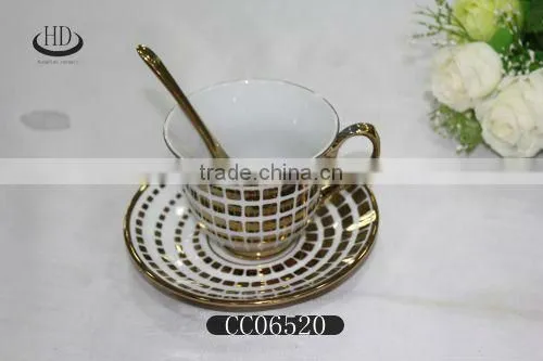 gold rim ceramic coffee cup and saucer