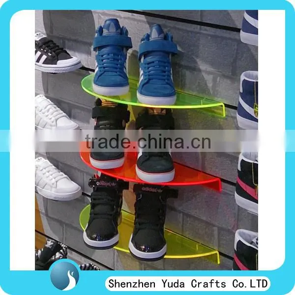 Many fluorescent colored semicircular plexiglass slatwall display rack