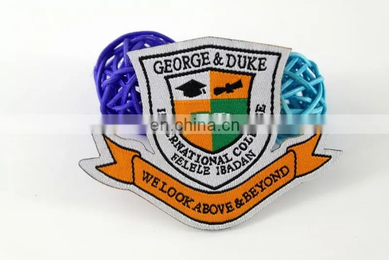 die cut shape with logo book and bird woven military emblems
