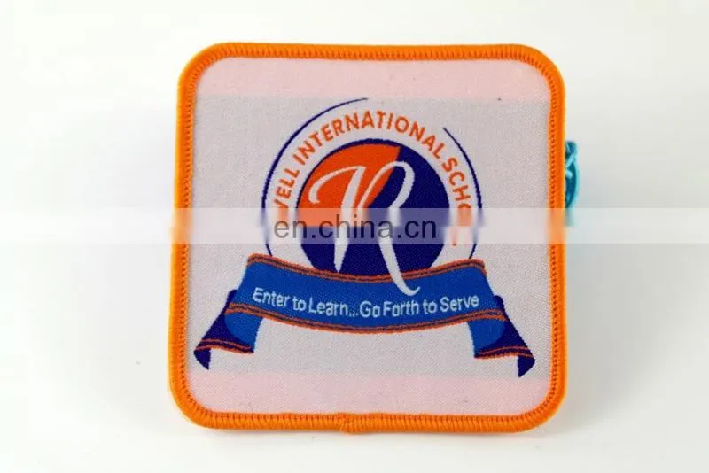 die cut shape with logo book and bird woven military emblems