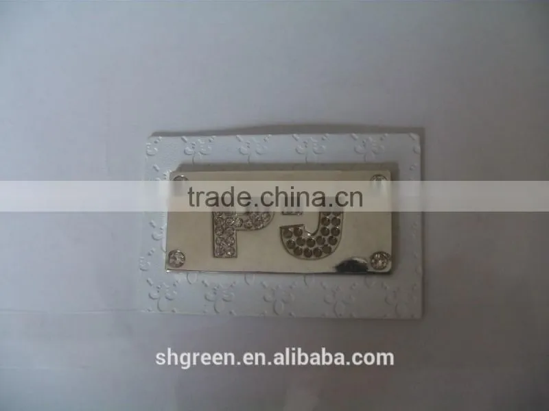 Promotional white real leather label with engraved logo metal plate