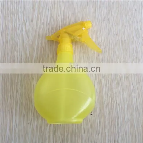 yellow transparent plastic garden spray bottle with trigger