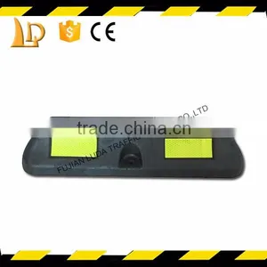 Synthetic Materials With Yellow Reflective Car Parking Stops On Road thumbnail-1