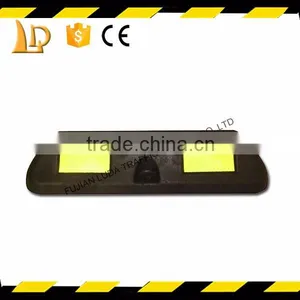 Synthetic Materials With Yellow Reflective Car Parking Stops On Road thumbnail-3