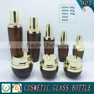 Amber Coloured Cosmetics Glass Bottle and Glass Cream Jar With Shining Gold Lid thumbnail-1