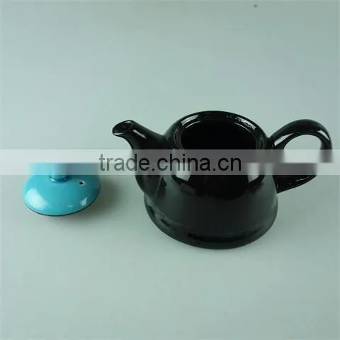 Glazed Black Teapot With Blue Cover in Stock photo-2