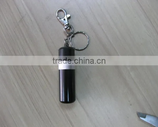 pill holder keychain with a pen