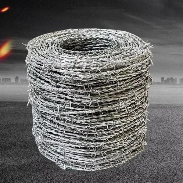 Green razor-sharp spiral barbed wire, stainless steel coil, for security applications.