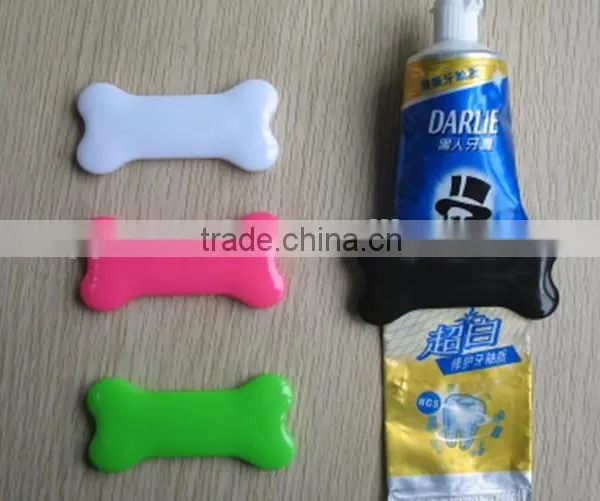 plastic bone shape toothpaste squeezer