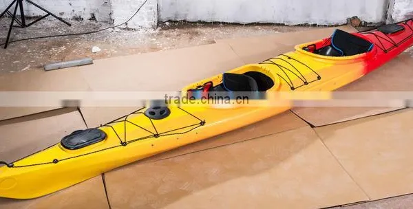 two person sit in ocean kayak