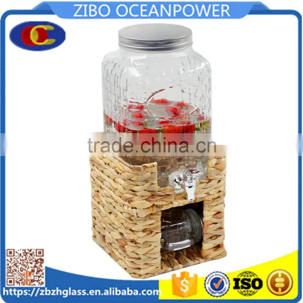 Glass Beverage Dispenser on Grass Stand