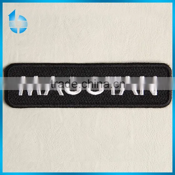 Overlocked sewing embroidery label with thermosol cementing on backside for business clothing